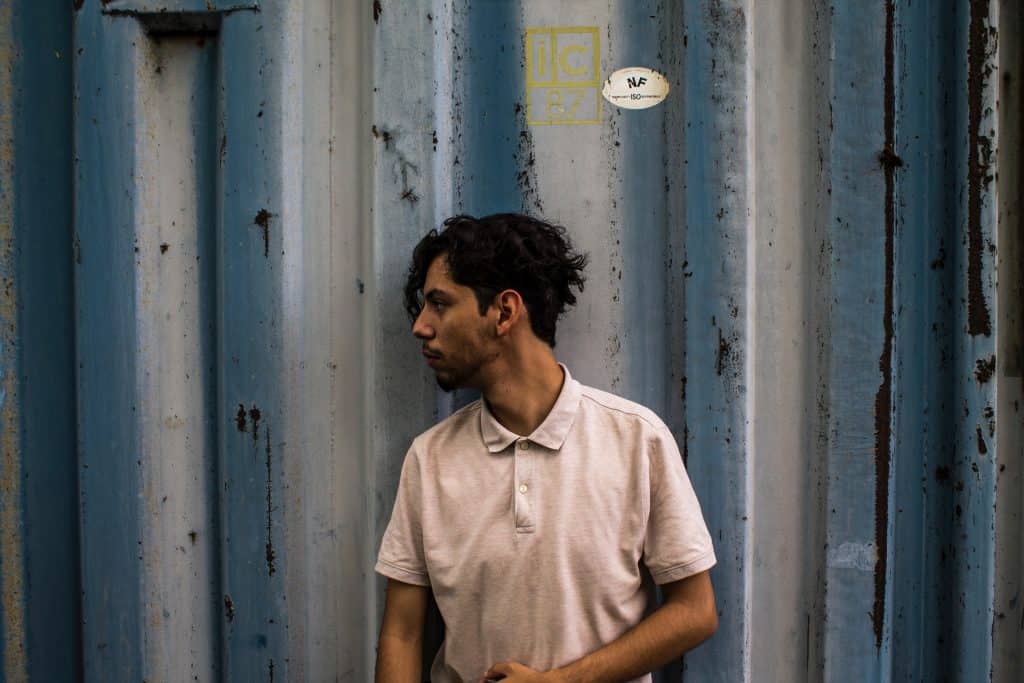 man-with-curly-hair-and-beige-shirt